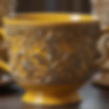 Close-up of intricate design on antique yellow cup